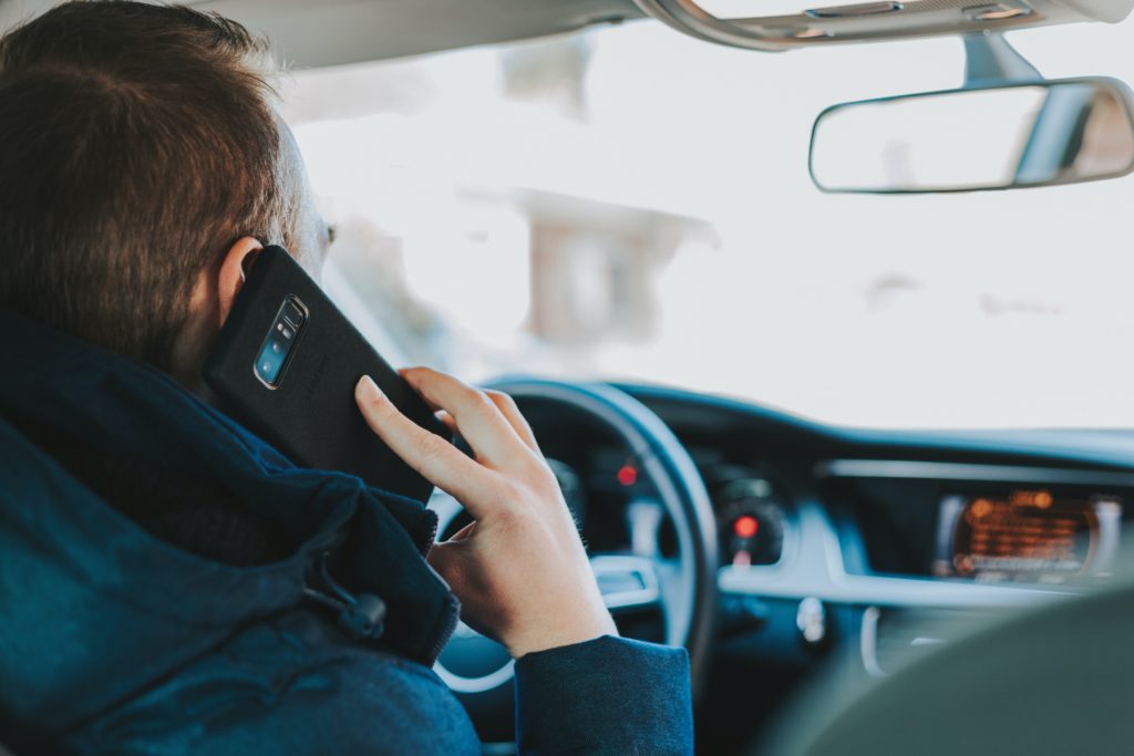 Homme appelant sa banque pour éviter une arnaque lors de l'achat d'une voiture d'occasion